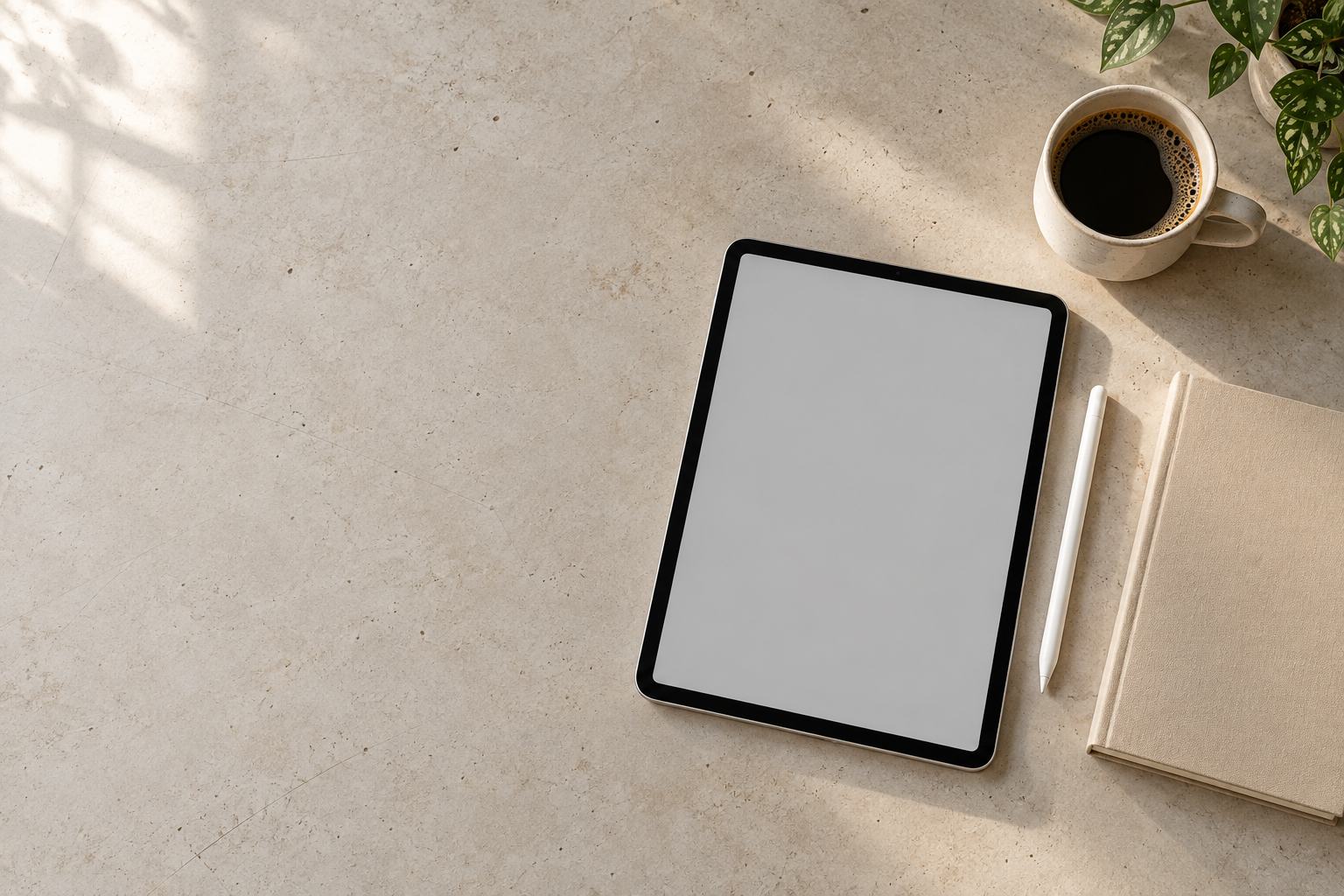 A wooden desk with a tablet, a stylus and a mug